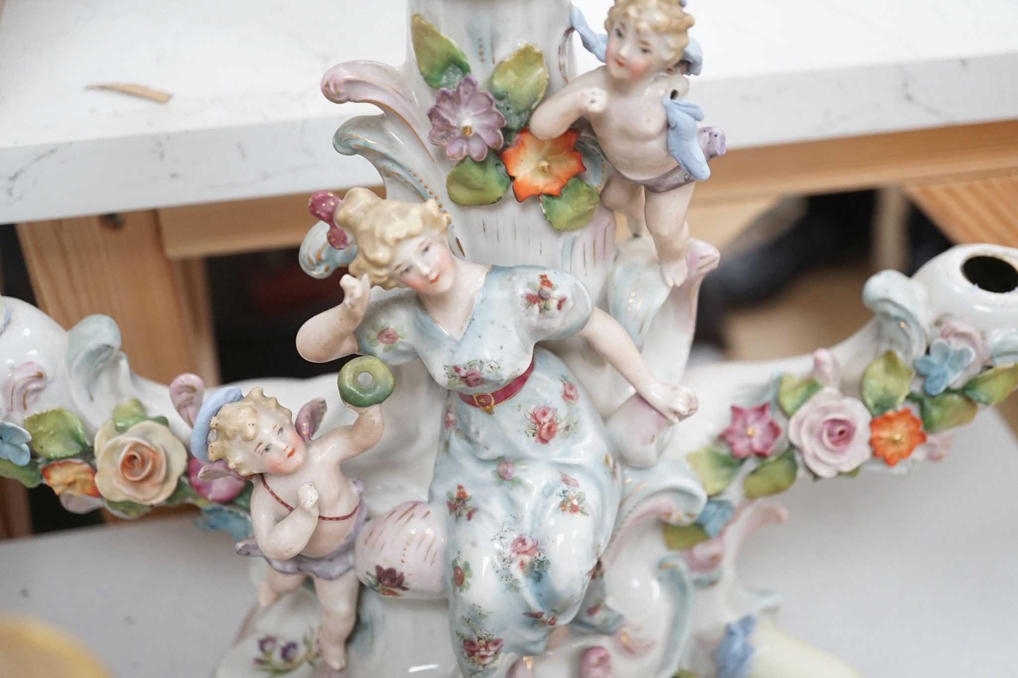 A group of Continental porcelain and pottery figural vases and centrepieces and two candelabra